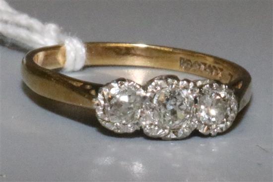 Illusion set three stone diamond ring in 18ct gold and platinum setting.
